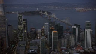 AX0174_0108 - 6K aerial stock footage of the Bay Bridge, seen from Downtown San Francisco at twilight, California