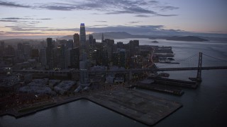 AX0174_0110 - 6K aerial stock footage of a reverse view of Downtown San Francisco skyscrapers at twilight, California