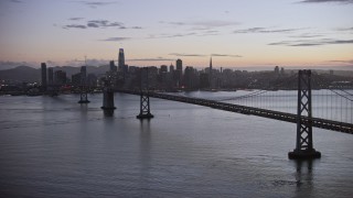 AX0174_0114 - 6K aerial stock footage of the Downtown San Francisco skyline and Bay Bridge at twilight, California