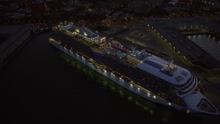 AX0174_0121 - 6K aerial stock footage of a cruise ship docked at North Beach at twilight, San Francisco, California