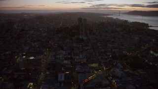 AX0174_0123 - 6K aerial stock footage of flying toward apartment buildings in Russian Hill at twilight, San Francisco, California