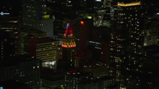 AX0174_0131 - 6K stock footage aerial video of Tribune Tower in Downtown Oakland at night, California