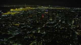 AX0174_0132 - 6K aerial stock footage of Tribune Tower and office buildings in Downtown Oakland at night, California