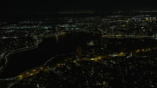 AX0174_0133 - 6K aerial stock footage of Lake Merritt near Downtown Oakland at night, California