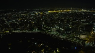 AX0174_0134 - 6K stock footage aerial video approach and fly over waterfront office buildings in Downtown Oakland at night, California
