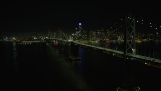 AX0174_0138 - 6K aerial stock footage of the Bay Bridge and Downtown San Francisco skyline at night, California