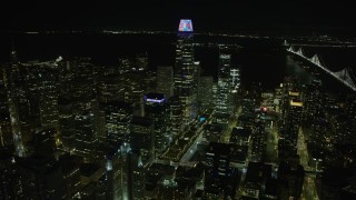 AX0174_0144 - 6K aerial stock footage approach and flyby Salesforce Tower at night, Downtown San Francisco, California