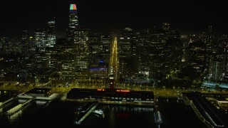 AX0174_0147 - 6K aerial stock footage fly over Ferry Building at night, follow Market Street through Downtown San Francisco, California