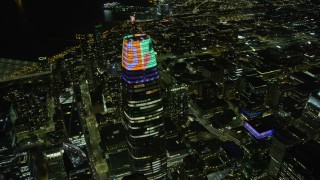 AX0174_0148 - 6K aerial stock footage flyby the top of Salesforce Tower at night in Downtown San Francisco, California