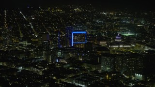 AX0174_0155 - 6K stock footage aerial video of apartment complex and San Francisco City Hall at night, California