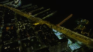 AX0174_0158 - 6K aerial stock footage fly over Downtown San Francisco, tilt to skyscrapers and piers at night, California