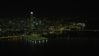 AX0174_0161 - 6K aerial stock footage reverse view of Bay Bridge and Downtown San Francisco skyline at night, California