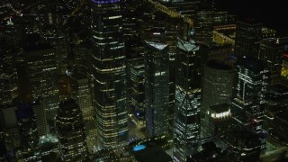 AX0174_0167 - 6K aerial stock footage of orbiting skyscrapers in Downtown San Francisco at night, California