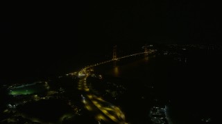 AX0174_0176 - 6K aerial stock footage follow 101 to approach the Golden Gate Bridge from Presidio at night, California
