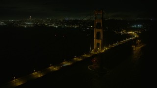 AX0174_0180 - 6K stock footage aerial video flyby the Golden Gate Bridge at night with San Francisco in the background, California