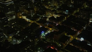 AX0174_0185 - 6K aerial stock footage of Chinatown office and apartment buildings at night, San Francisco, California