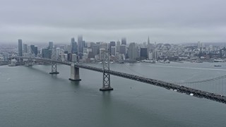 AX0175_0002 - 6K stock footage aerial video flying past the Bay Bridge with a wide view of Downtown San Francisco, California