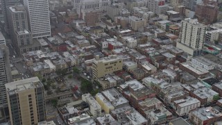 AX0175_0012 - 6K aerial stock footage of office and apartment buildings in Chinatown, San Francisco on a foggy day, California