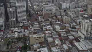 AX0175_0013 - 6K aerial stock footage orbit office and apartment buildings in Chinatown, San Francisco on a foggy day, California