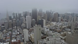 AX0175_0014 - 6K stock footage aerial video of downtown skyscrapers in San Francisco on a foggy day, California