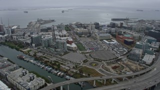 AX0175_0017 - 6K aerial stock footage of office buildings near the arena in San Francisco on a foggy day, California