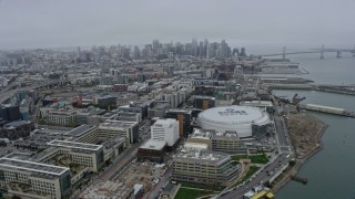AX0175_0018 - 6K aerial stock footage of downtown skyscrapers seen from Chase Center in San Francisco on a foggy day, California