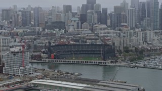 AX0175_0019 - 6K aerial stock footage of Oracle Park in San Francisco on a foggy day, California
