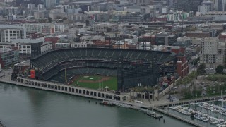 AX0175_0020 - 6K aerial stock footage of the Oracle Park baseball stadium in San Francisco on a foggy day, California