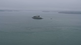 AX0175_0023 - 6K aerial stock footage approaching Alcatraz on a foggy day, California