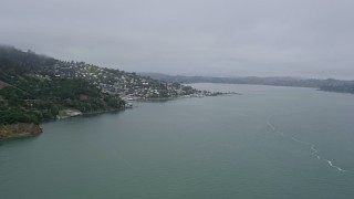 AX0175_0032 - 6K aerial stock footage flyby cliffs to reveal Sausalito on a foggy day, California