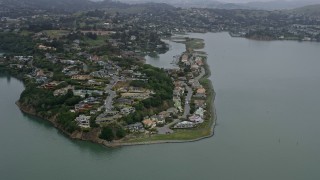 AX0175_0037 - 6K aerial stock footage of waterfront mansions in Mill Valley on a foggy day, California