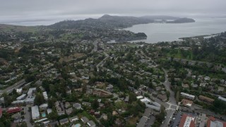 AX0175_0060 - 6K aerial stock footage flyby suburban neighborhoods in Mill Valley on a foggy day, California
