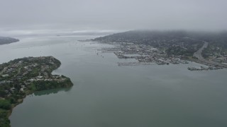 AX0175_0062 - 6K stock footage aerial video tilt from Mill Valley to reveal Sausalito on a foggy day, California