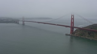 AX0175_0067 - 6K aerial stock footage of passing by the Golden Gate Bridge on a foggy day, San Francisco, California
