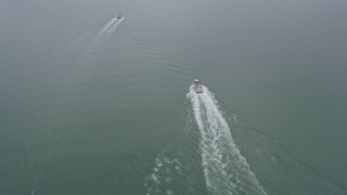 AX0175_0068 - 6K aerial stock footage of ferries sailing San Francisco Bay on a foggy day, San Francisco, California