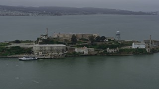 AX0175_0069 - 6K aerial stock footage of orbiting Alcatraz on a foggy day, California
