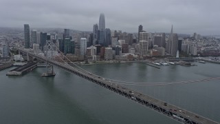 AX0175_0076 - 6K aerial stock footage of Downtown San Francisco on a foggy day, seen from the Bay Bridge, California