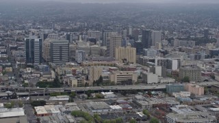 AX0175_0082 - 6K aerial stock footage of approaching Downtown Oakland on a foggy day, California