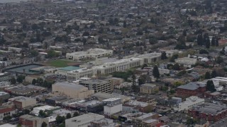 AX0175_0089 - 6K aerial stock footage of a theater and high school in Alameda, California