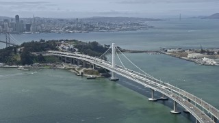 AX0175_0105 - 6K aerial stock footage flyby light traffic on the Bay Bridge, reveal Downtown San Francisco skyline, California