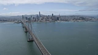 AX0175_0115 - 6K aerial stock footage fly over Bay Bridge while focused on Downtown San Francisco, California