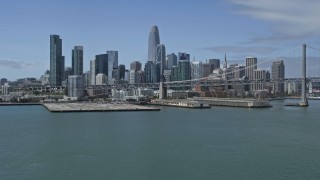 AX0175_0125 - 6K aerial stock footage tilt from the bay to reveal and approach Downtown San Francisco skyline, California