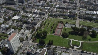 AX0175_0128 - 6K aerial stock footage of tennis courts at a park in Pacific Heights, San Francisco, California