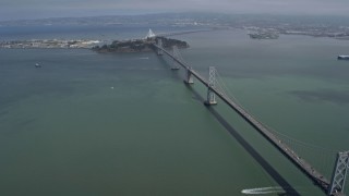 AX0175_0132 - 6K aerial stock footage tilt from the Bay Bridge to reveal Yerba Buena Island, San Francisco, California