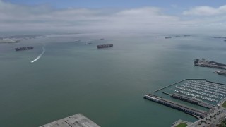 AX0175_0145 - 6K aerial stock footage approach cargo ships sailing San Francisco Bay, California