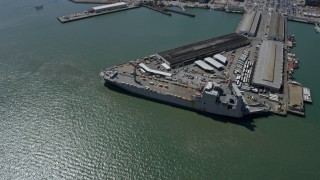 AX0175_0147 - 6K aerial stock footage of a Naval ship docked at Pier 50, San Francisco, California