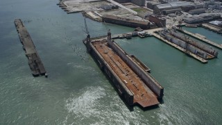 AX0175_0148 - 6K aerial stock footage of a dry dock in San Francisco, California