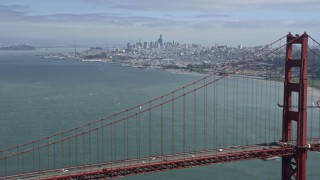 AX0175_0169 - 6K aerial stock footage flyby Golden Gate Bridge with view of distant Downtown San Francisco, California