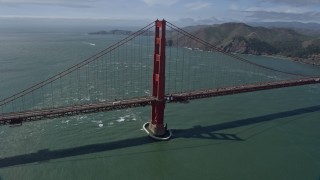 AX0175_0177 - 6K aerial stock footage of circling a tower on the Golden Gate Bridge, San Francisco, California