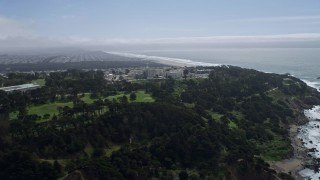 AX0175_0180 - 6K aerial stock footage of approaching a hospital overlooking the ocean, Seacliff, San Francisco, California